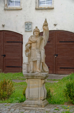 Figura Świętego Floriana przed budynkiem remizy strażackiej. Nowy Waliszów, gmina Bystrzyca Kłodzka, powiat kłodzki, woj. dolnośląskie.