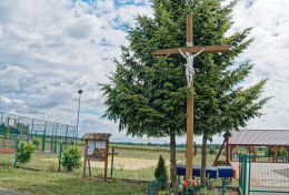Krzyż drewniany stojący obok Szkoły Podstawowej. Nowe Grodzisko, gmina Milicz, powiat milicki, woj. dolnośląskie.