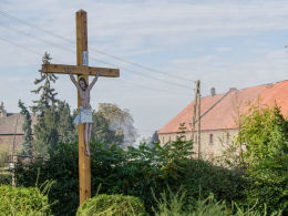 Drewniany krzyż przydrożny z blaszaną figurą Chrystusa. Mikołajów, gmina Stoszowice, powiat ząbkowicki.