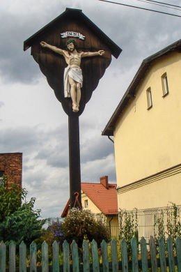 Drewniany krzyż przydrożny z początków XIX z figurą Chrystusa. Ulica Wolności 21. Mikołów, Paniowy, powiat mikołowski.